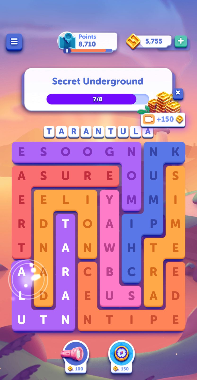 Word puzzle game with word 'TARANTULA' highlighted.