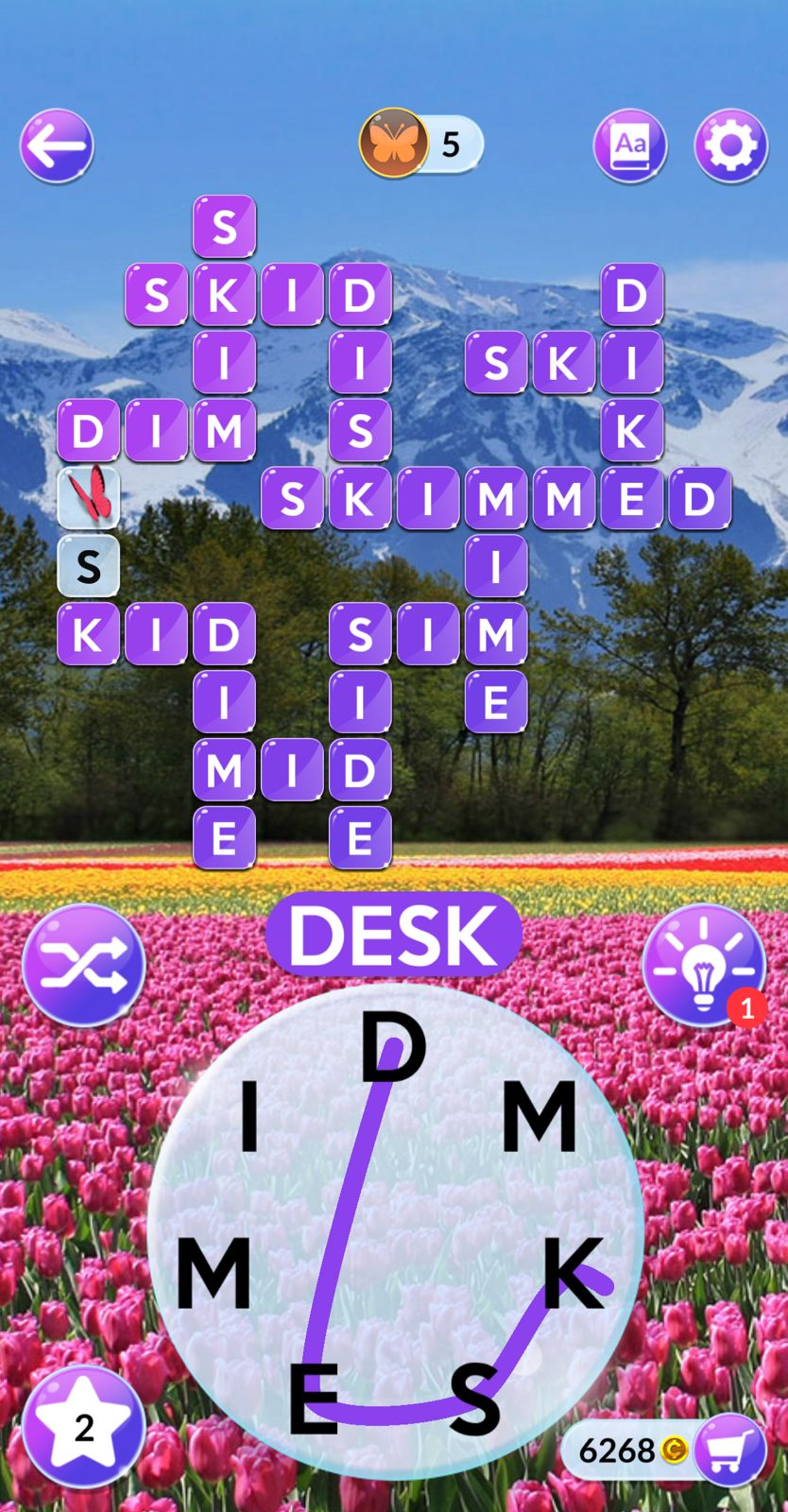 Word puzzle game with mountain and tulip background.