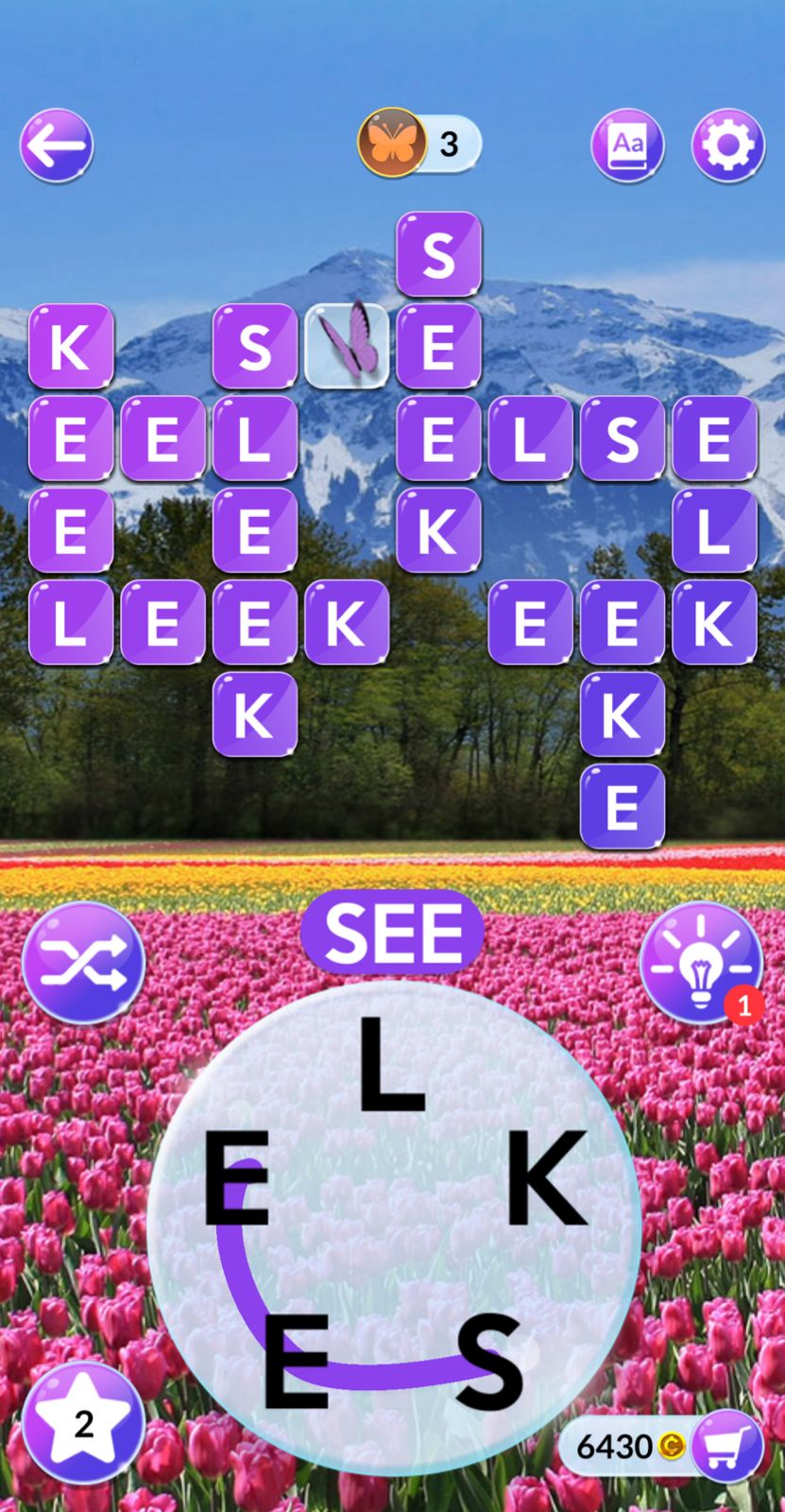 Word puzzle game with mountain and tulip background.